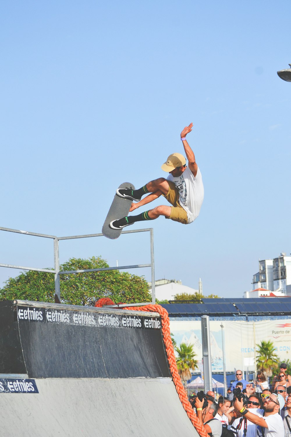 people watching beside man doing skateboard trick