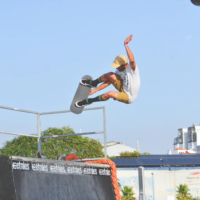 People standing on a city street watching a skateboarder in mid trick