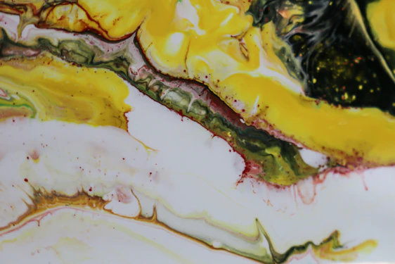 A colorful abstract painting featuring swirling silver, orange, yellow, blue, and green shapes with sharp black highlights.