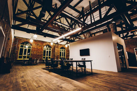 Cozy village hall room set up for a community meeting with natural light and wooden beams.