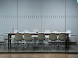 A minimalist conference table surrounded by comfortable chairs.