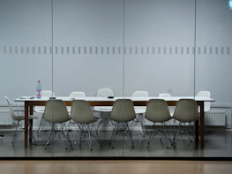 A conference room with neatly arranged Apple devices and network equipment ready for use.