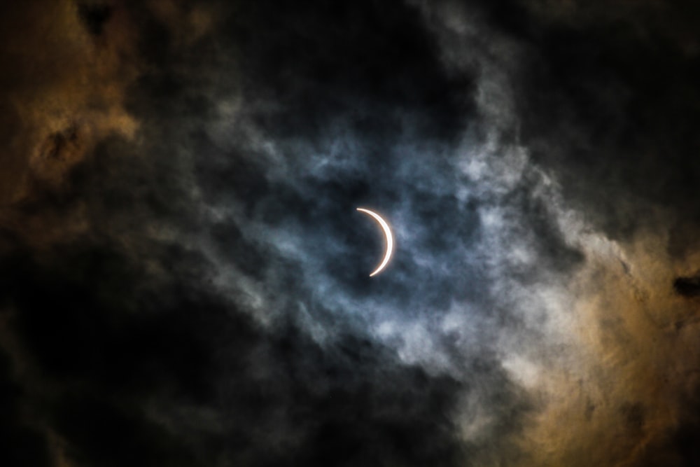 crescent moon covered with clouds