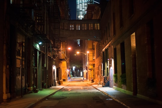 empty street in between of buildings during nighttime in Tribeca United States