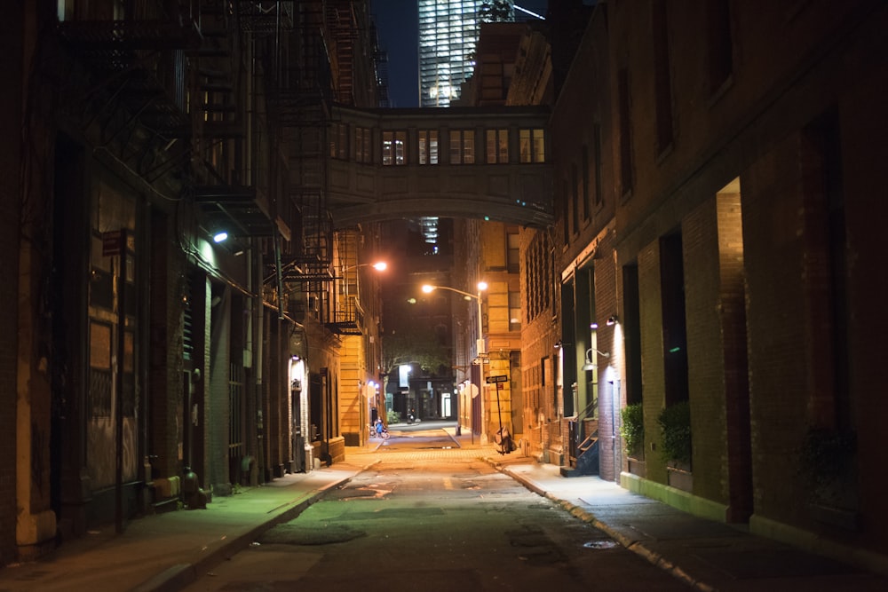 empty street in between of buildings during nighttime