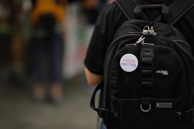Close-up of a men's backpack showing multiple compartments and sturdy zippers.