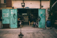 A 20-foot container repurposed as a small workshop with open doors.