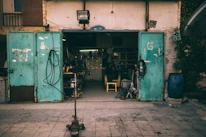 Close-up of a virtual door opening to reveal a busy workshop inside.