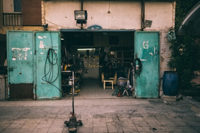 A sturdy garage door standing open, revealing a clean and organized workshop behind.