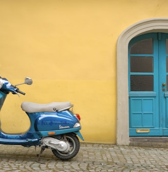 blue scooter motorcycle outside house