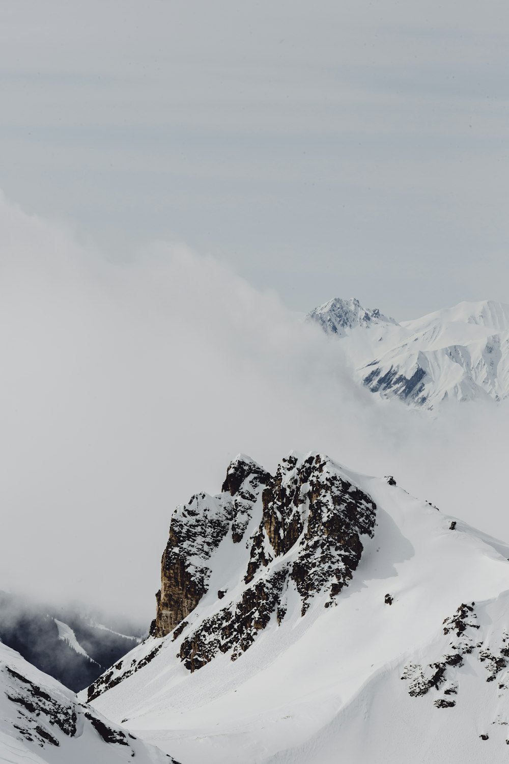 mountains covering snow during daytime