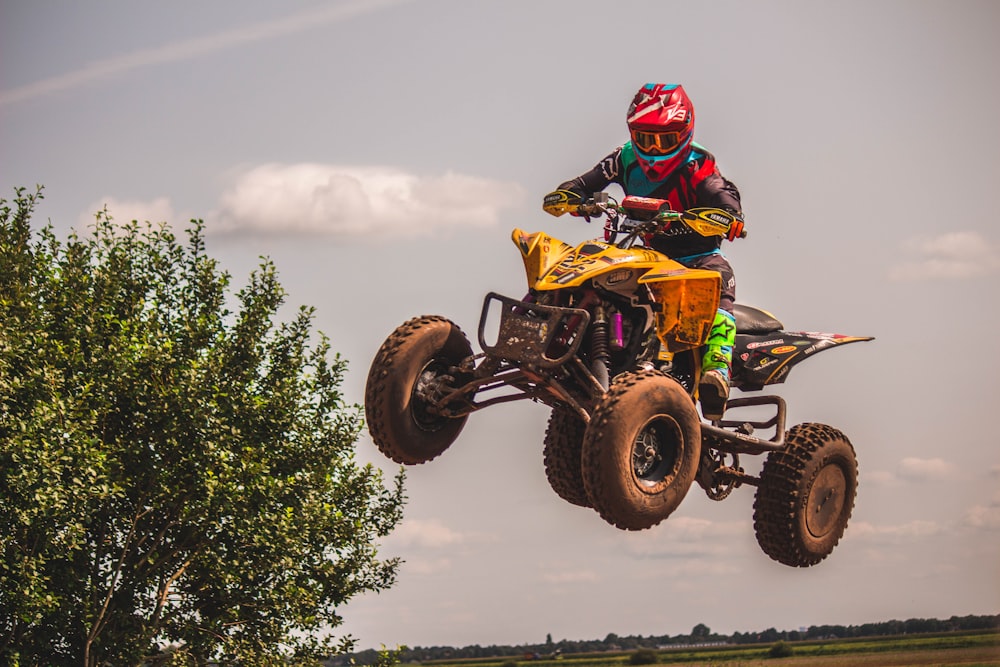 person riding yellow and black ATV