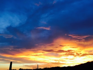 Sunset over the desert landscape surrounding Maicao, with warm red and blue hues.