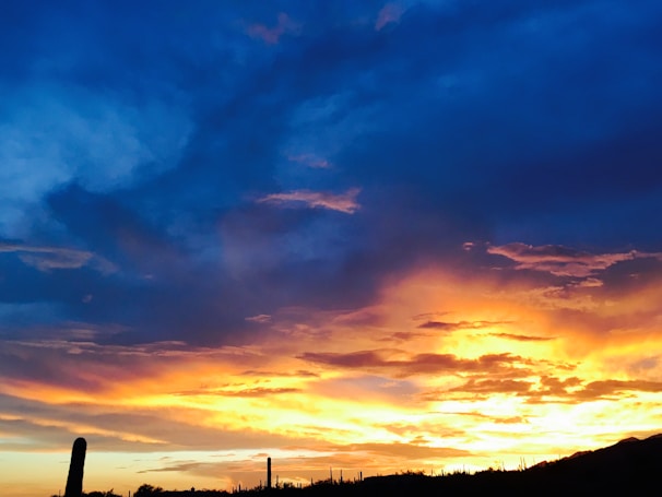 Sunset over the desert landscape surrounding Maicao, with warm red and blue hues.