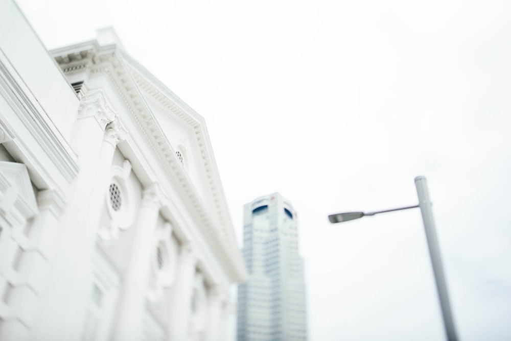 low angle of white post light in front of white concrete building