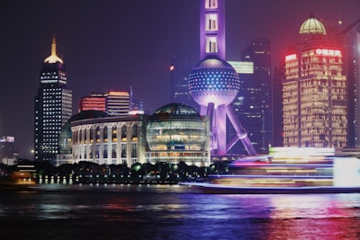 A vibrant 3D animation still featuring a futuristic cityscape glowing under neon lights.