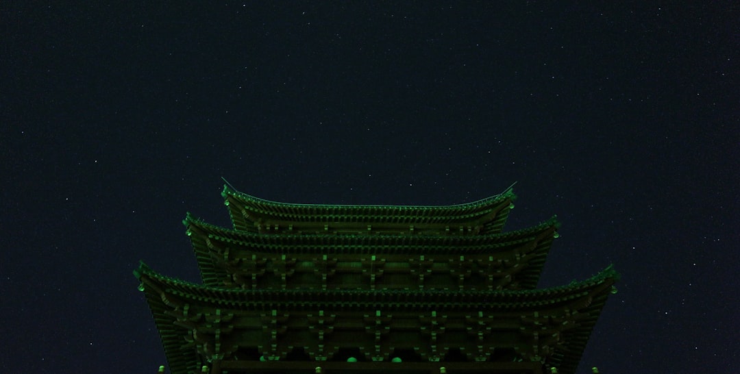 A building illuminated with green lights.