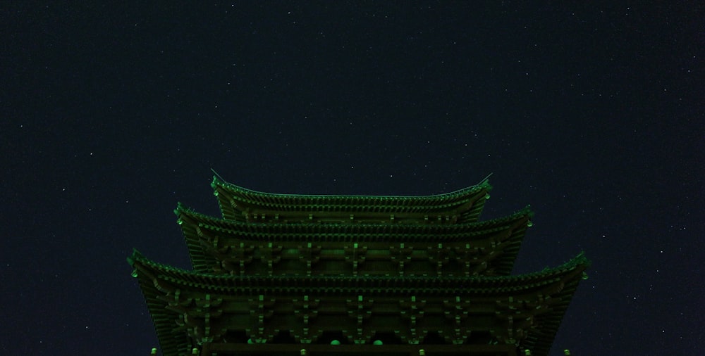 A building illuminated with green lights.