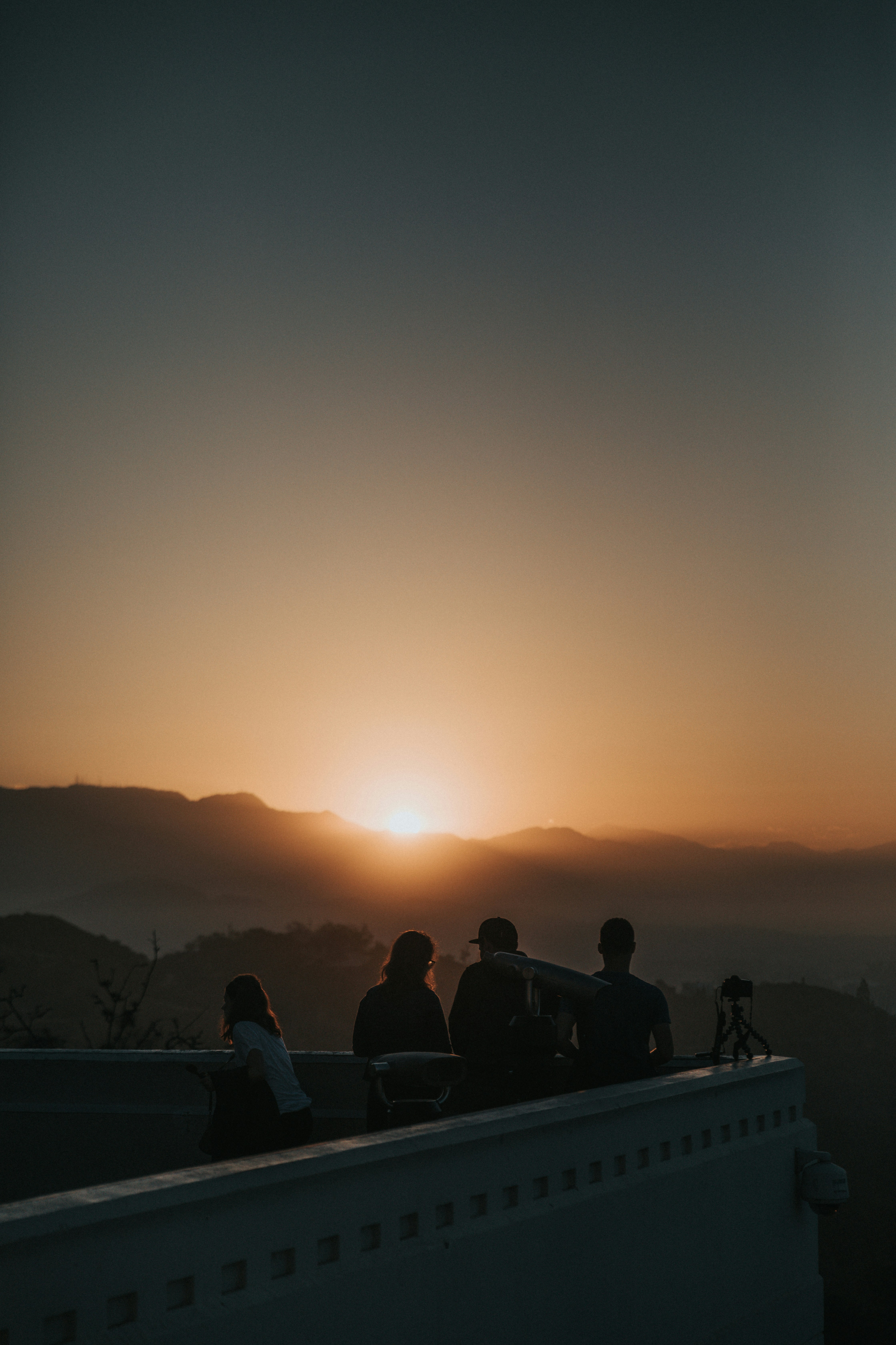 a group of people sitting on top of a roof