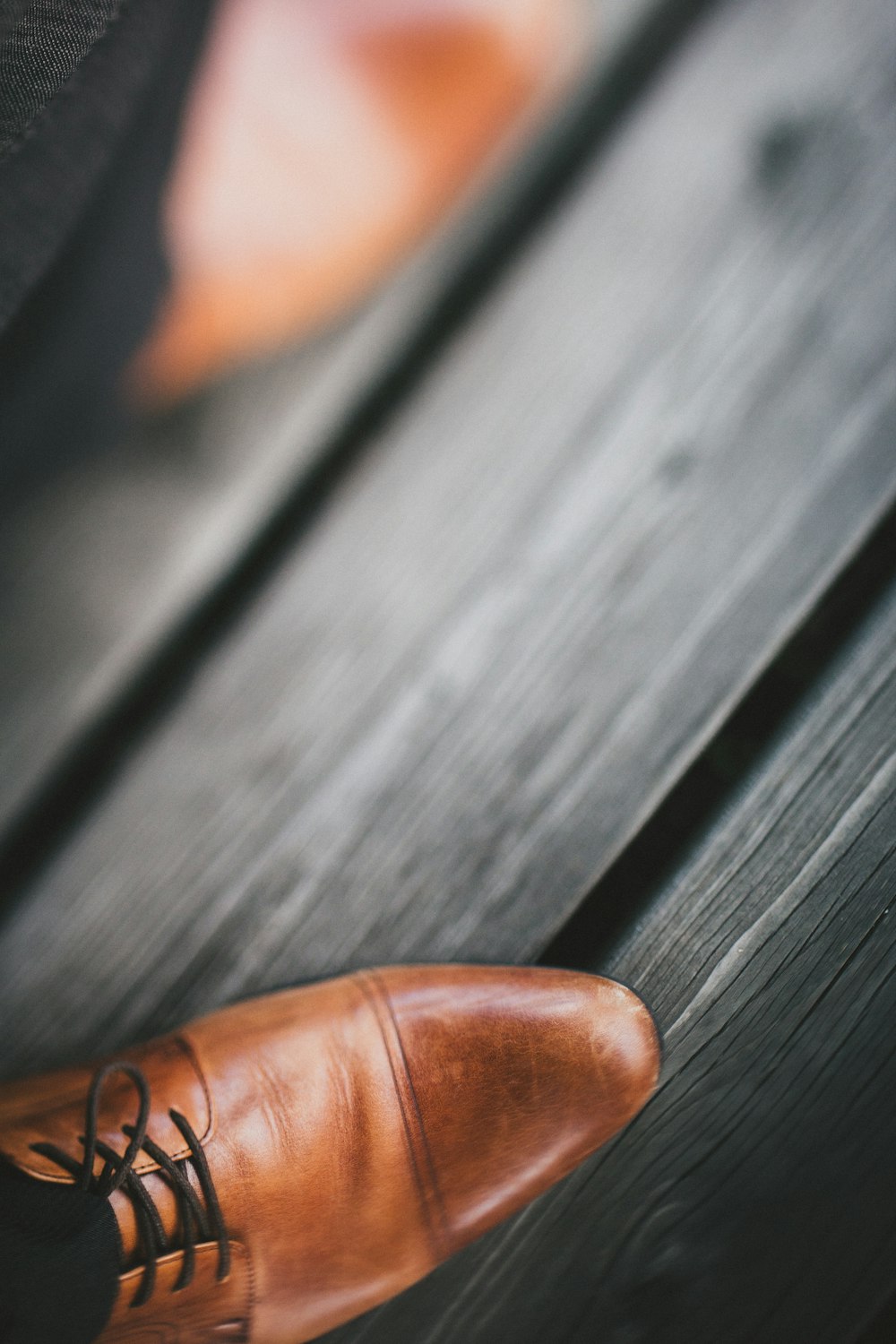 selective photography of brown leather dress shoe