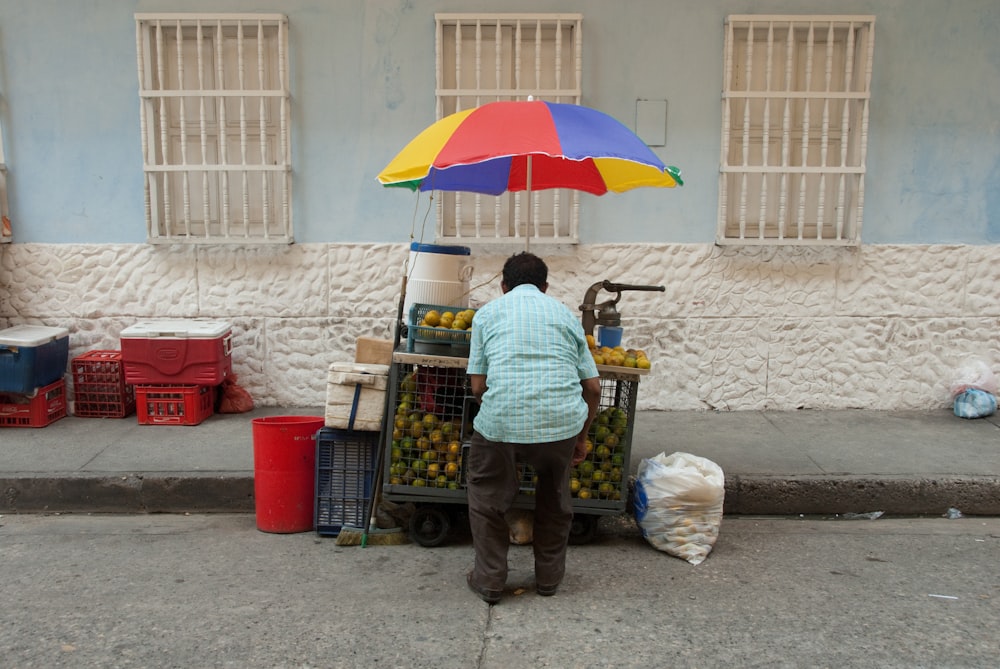 man standing near car beside street