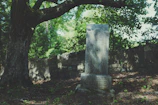 A granite tombstone with a smooth finish surrounded by fresh flowers under soft sunlight.