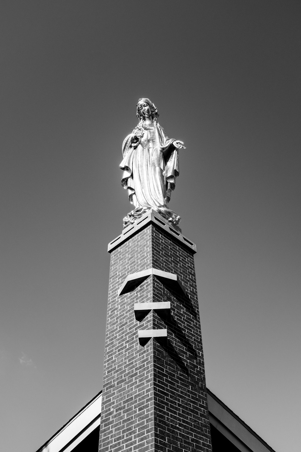 gray scale photo of woman statue