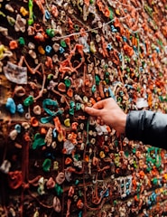 Hands smoothly applying a sleek adhesive board on a neutral-toned wall.
