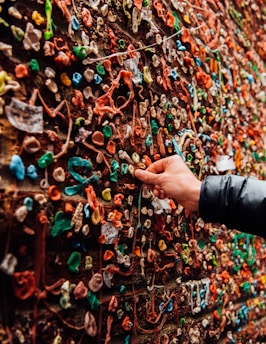 Hands smoothly applying a sleek adhesive board on a neutral-toned wall.