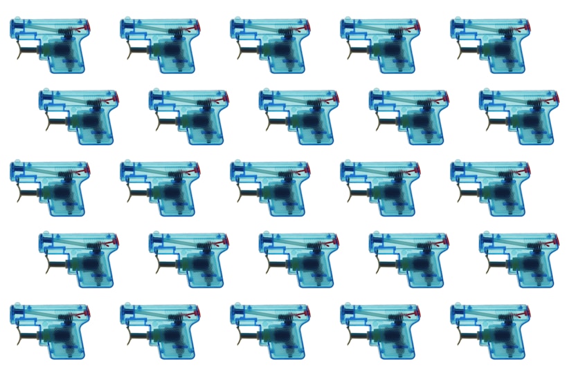 A grid pattern of multiple blue and transparent toy guns, each showing internal mechanics, arranged symmetrically on a white background.
