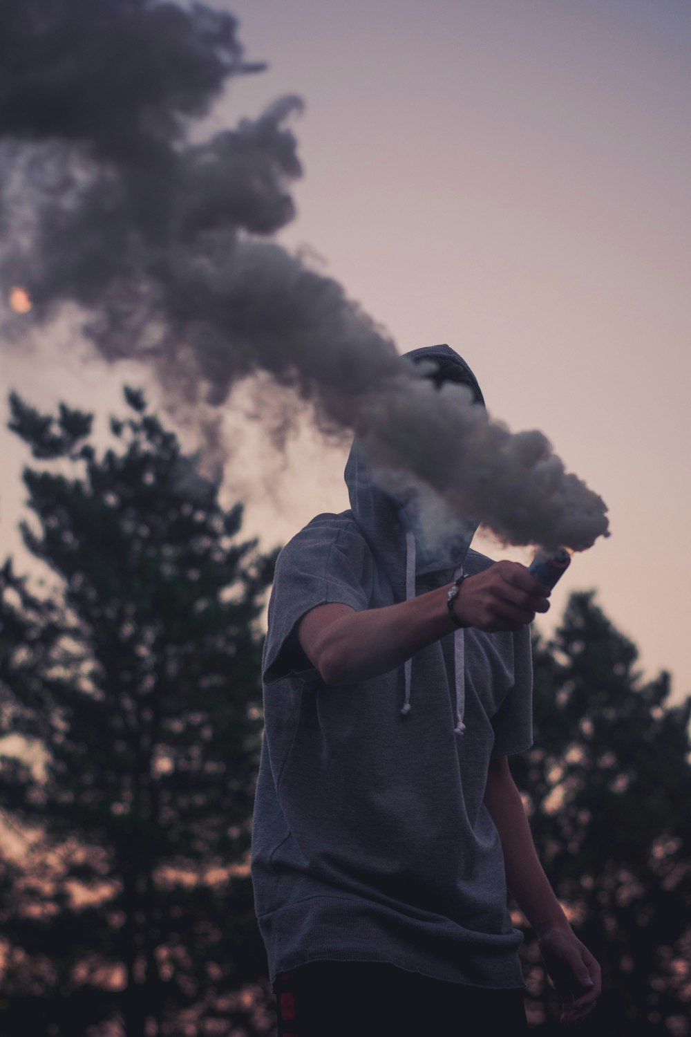 man holding smoke signal