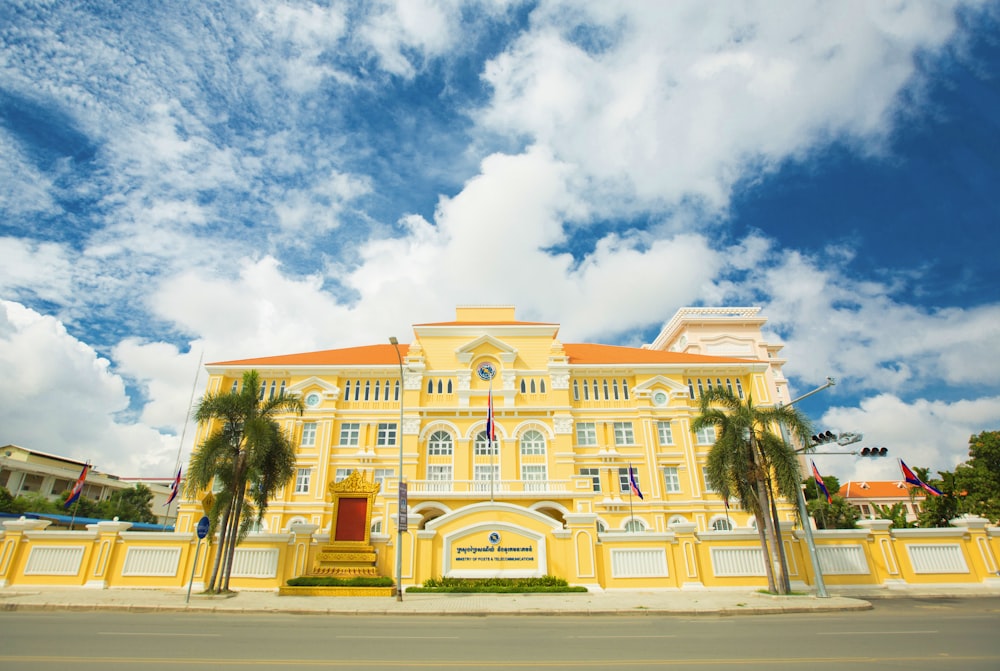 yellow building under cloudy sky during daytime