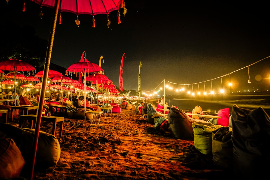 red umbrellas and yellow lights on shore