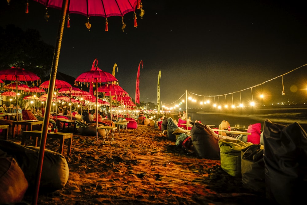 red umbrellas and yellow lights on shore