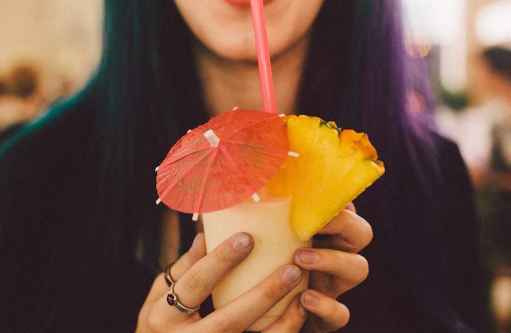 woman drinking shake using straw