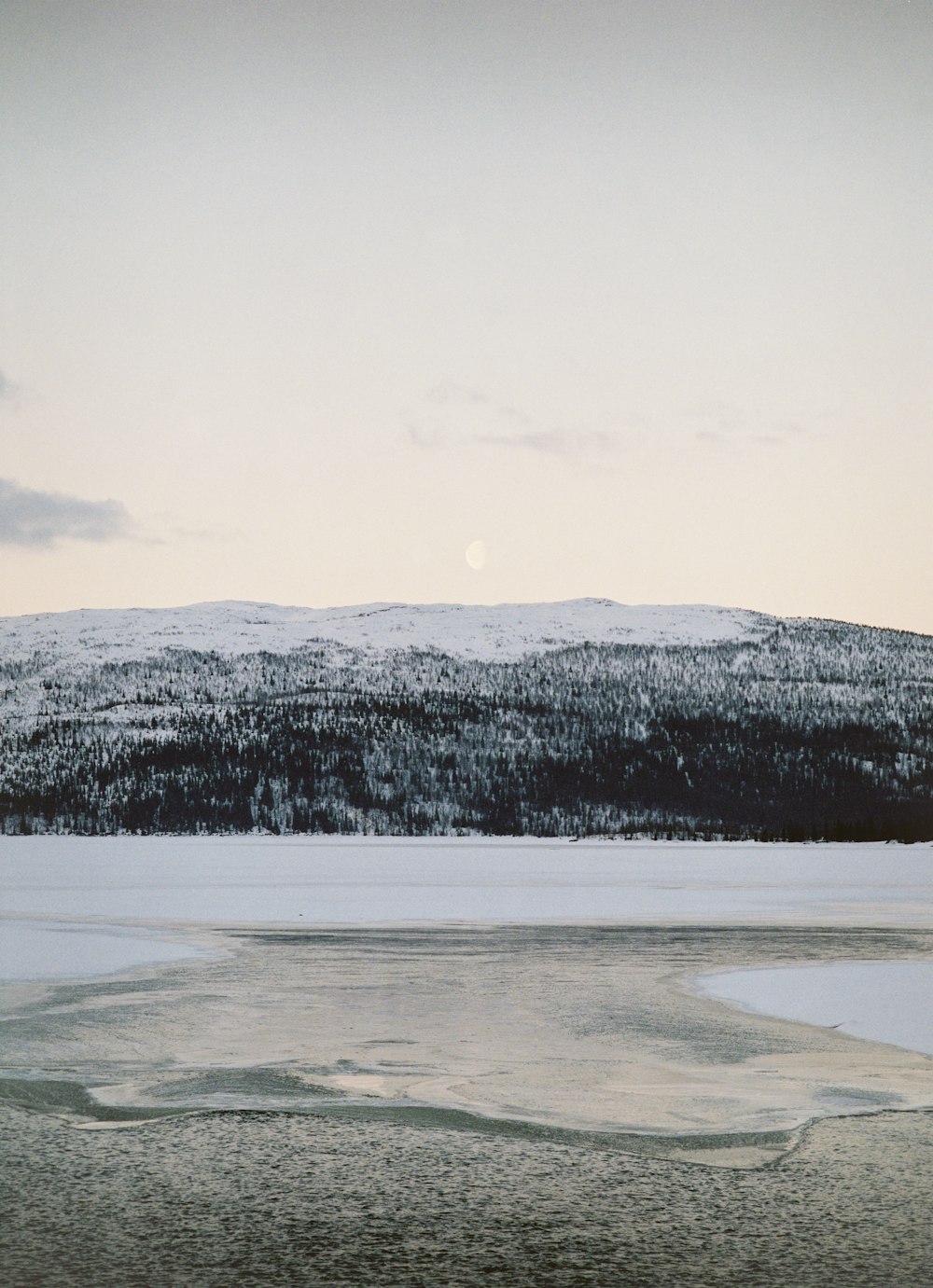 body of water beside mountain