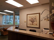 A welcoming office reception area with a friendly staff member ready to assist visitors.