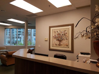 A welcoming office reception area with a friendly staff member ready to assist visitors.