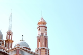 A serene landscape of a mosque with a clear blue sky.