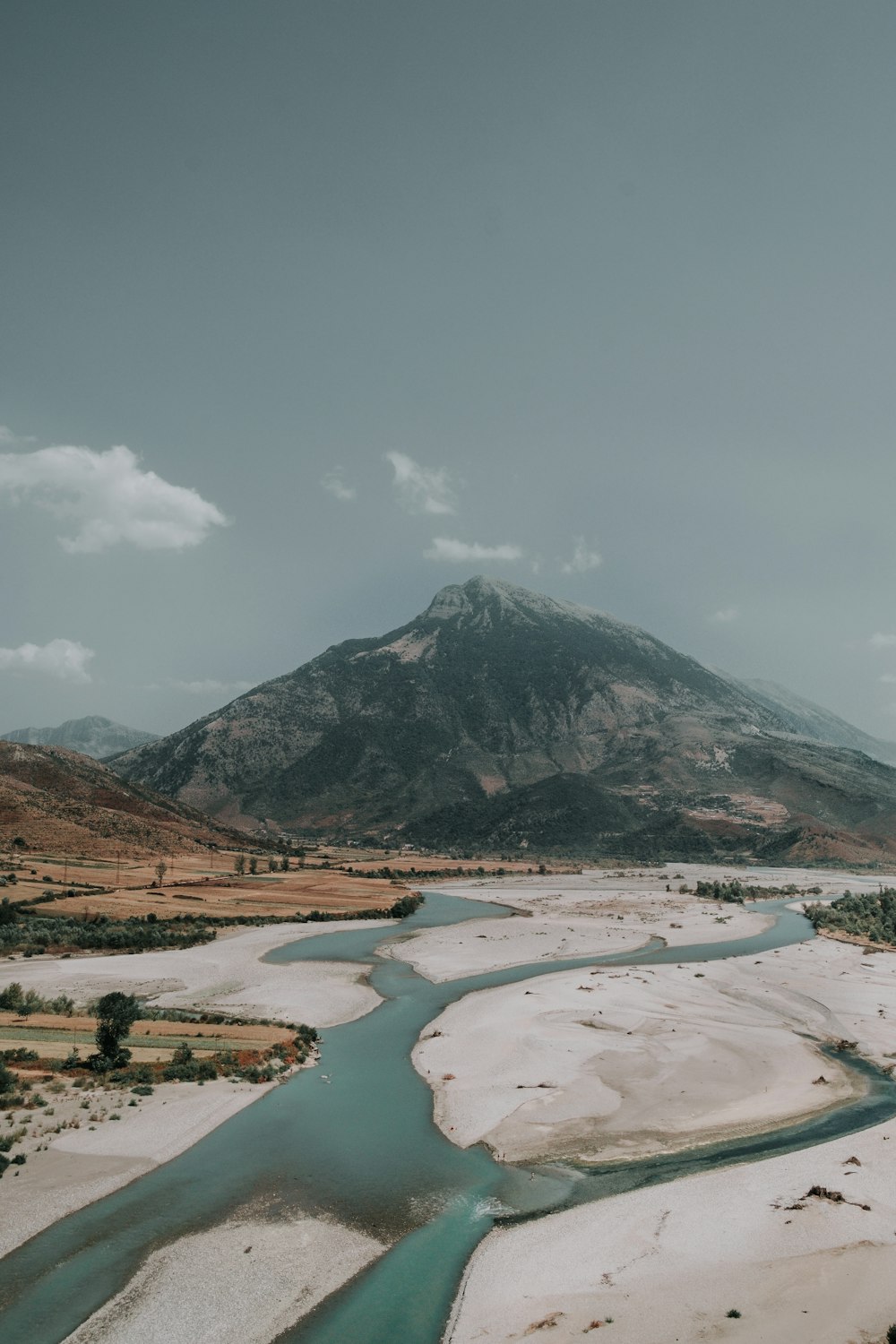 river near mountain at daytime