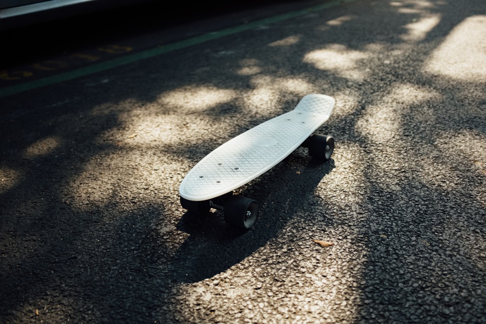 gray longboard on gray asphalt road