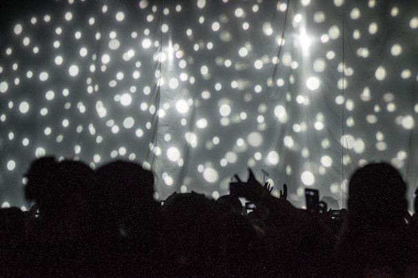 A vibrant collage of Hollywood stars on the red carpet under dazzling lights.