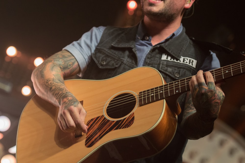 man playing guitar while singing