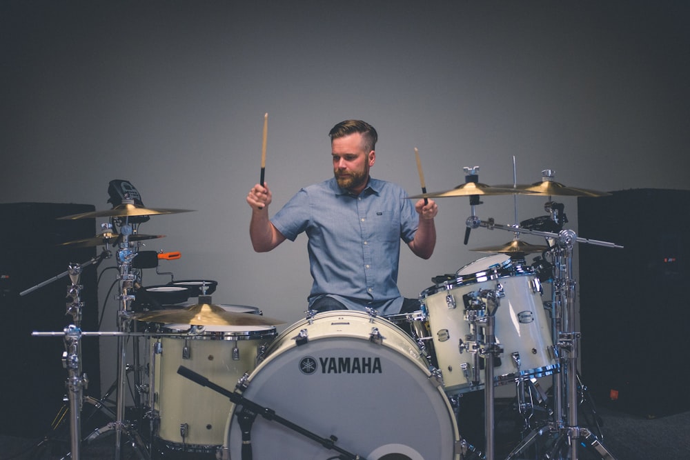 man holding drum sticks with sitting on throne