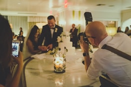 Professional photographer capturing a candid moment at a luxury wedding.