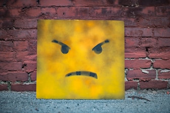 yellow and black smiley wall art