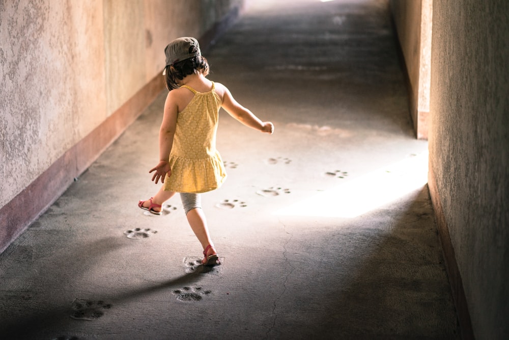 girl stepping on paw prints