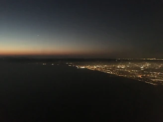 A glowing neural network pattern over a city skyline at dusk.