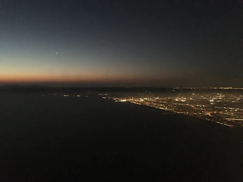 A glowing neural network pattern over a city skyline at dusk.