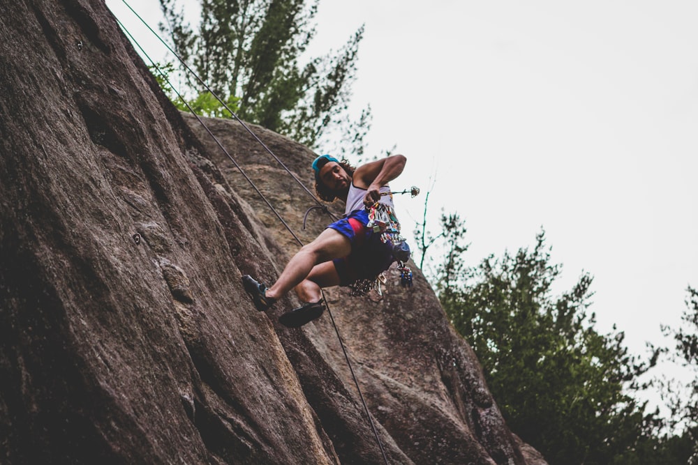 man mountain climbing during daytime